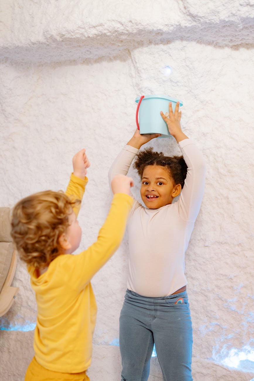 children playing with a bucket container